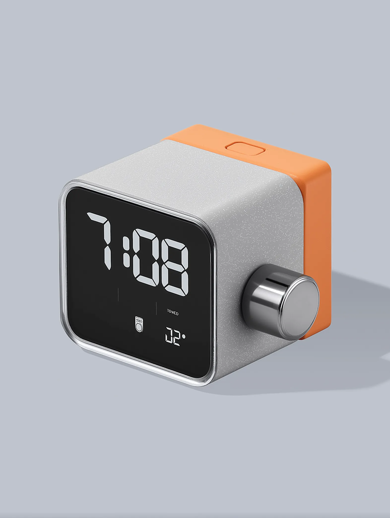 Digital alarm clock with orange top, gray body, silver knob, displaying time 7:08.